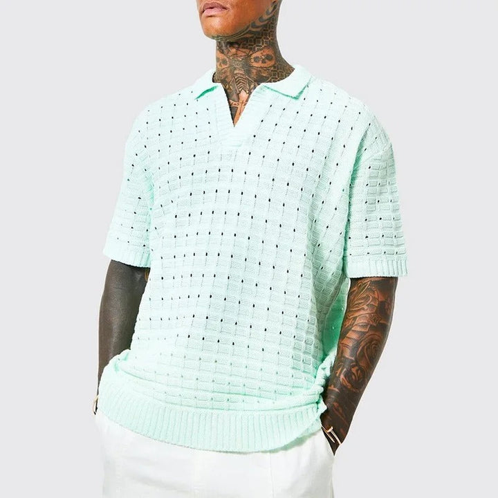 Trendy men's knitted polo shirt with breathable fabric and modern fit, perfect for casual and smart looks during summer days.