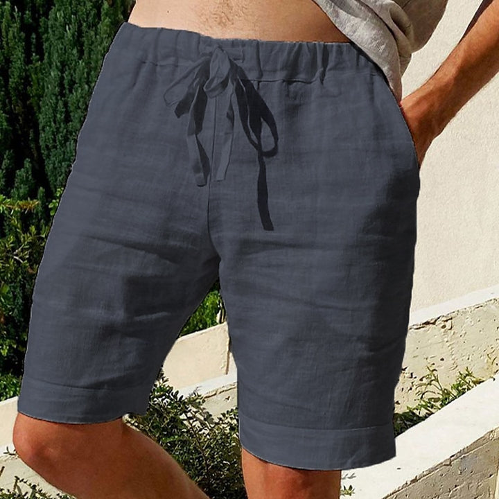 Comfy linen beach shorts with elastic waistband and lightweight, breathable fabric, perfect for summer relaxation.