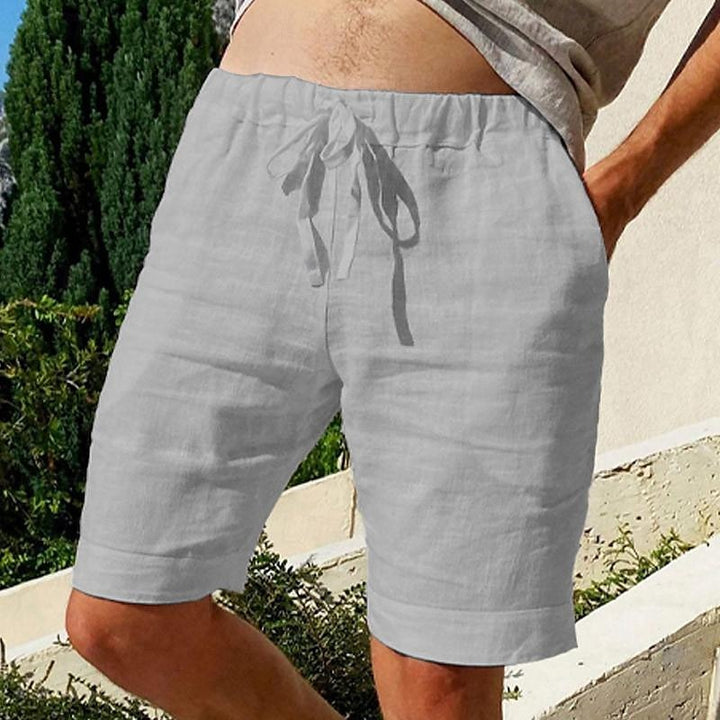 Comfy linen beach shorts with elastic waistband and lightweight, breathable fabric, perfect for summer relaxation.