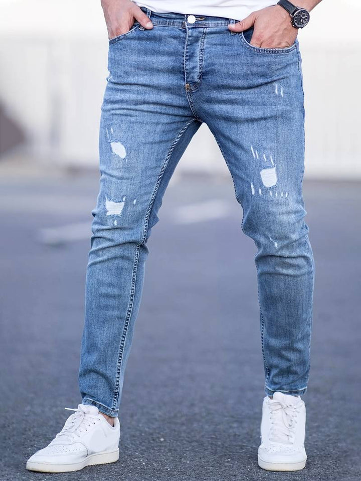 Men's classic ripped denim jeans with a trendy design, durable fabric, and comfortable fit, perfect for casual and summer looks.






