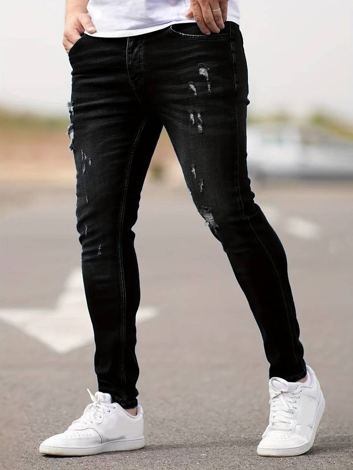 Men's classic ripped denim jeans with a trendy design, durable fabric, and comfortable fit, perfect for casual and summer looks.






