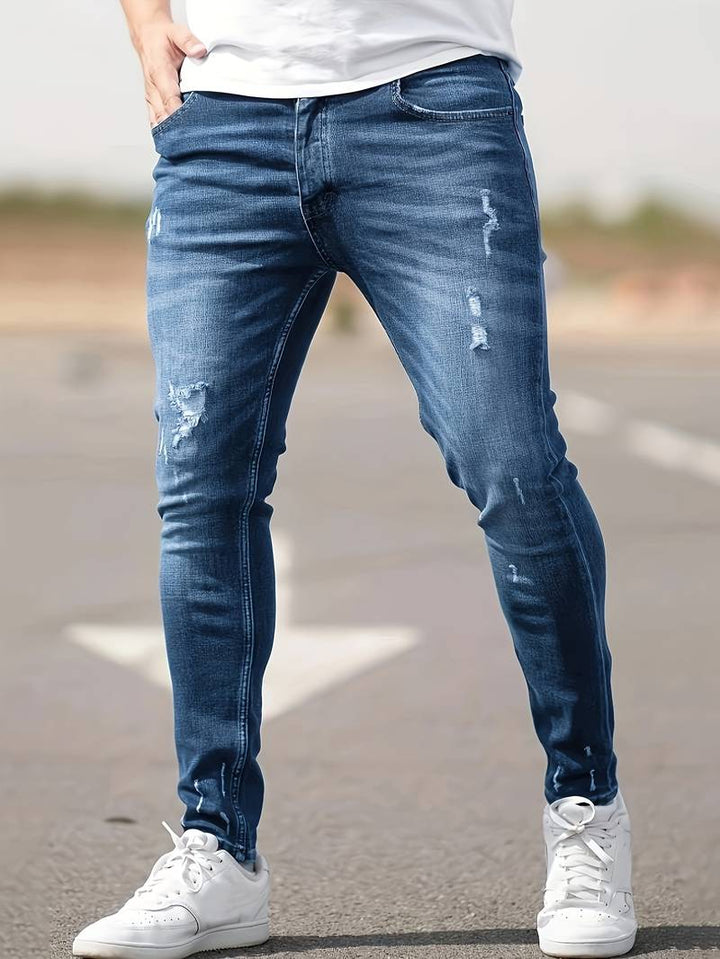 Men's classic ripped denim jeans with a trendy design, durable fabric, and comfortable fit, perfect for casual and summer looks.






