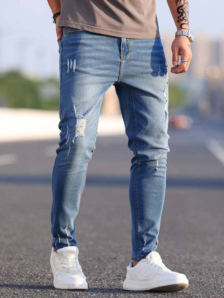 Men's classic ripped denim jeans with a trendy design, durable fabric, and comfortable fit, perfect for casual and summer looks.






