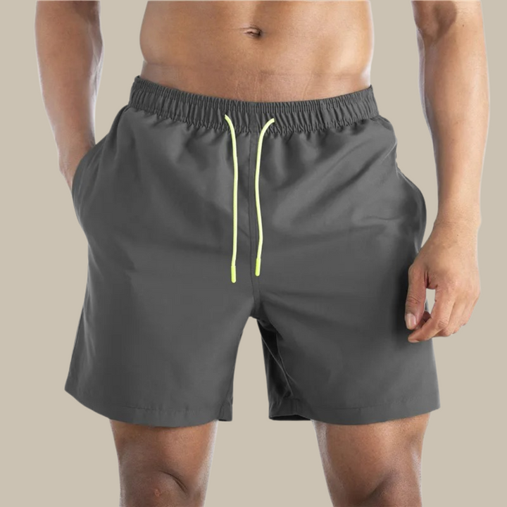 Men's casual quick-drying swim shorts with elastic waistband and lightweight design, ideal for active summer days by the water.






