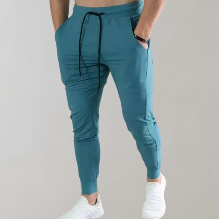 Men’s trendy slim-fit sweatpants with breathable fabric, elastic waistband, and versatile style, perfect for casual and summer wear.